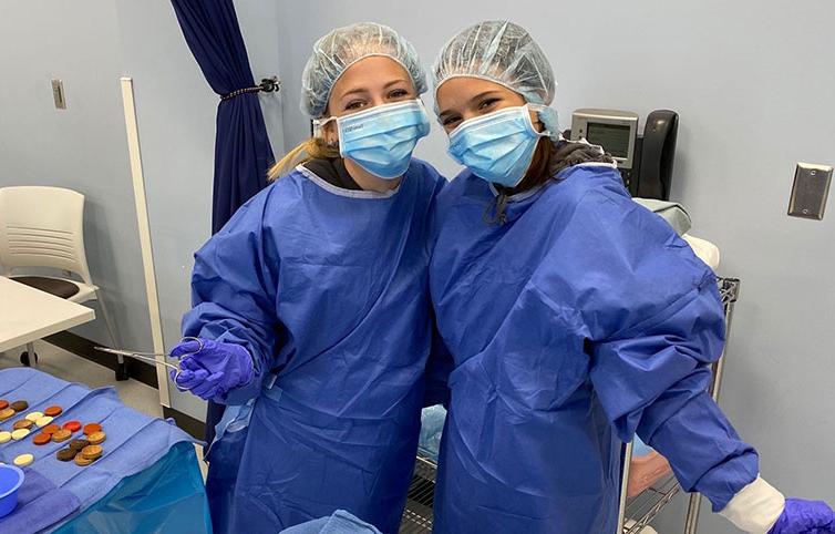 two high school students at scrubs camp in the Anoka Tech surgical technology lab